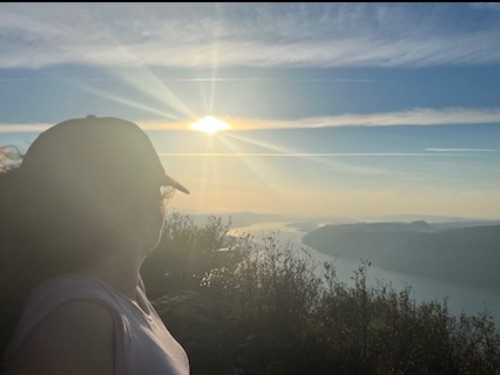 woman facing sunrise