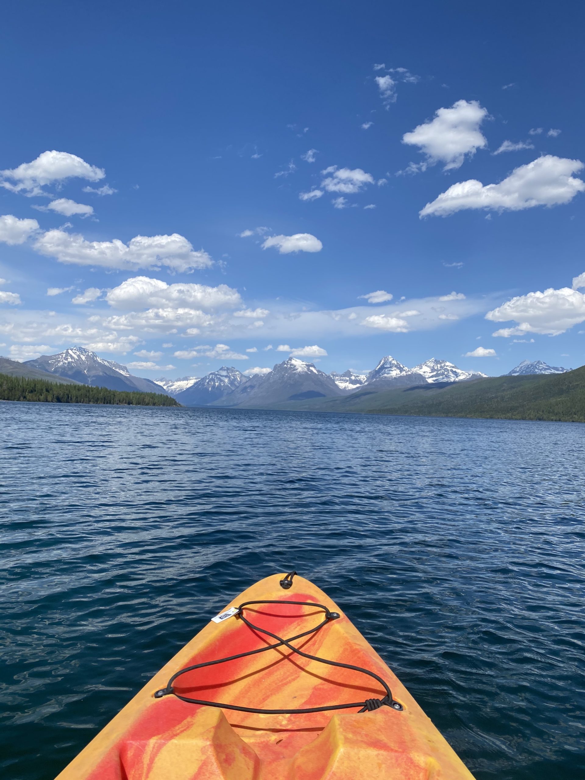 kayak on water facing bright blue sky