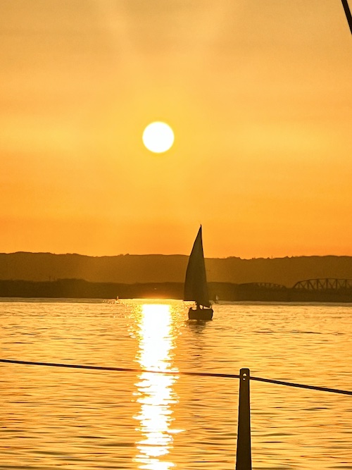sailboat on the water at sunrise