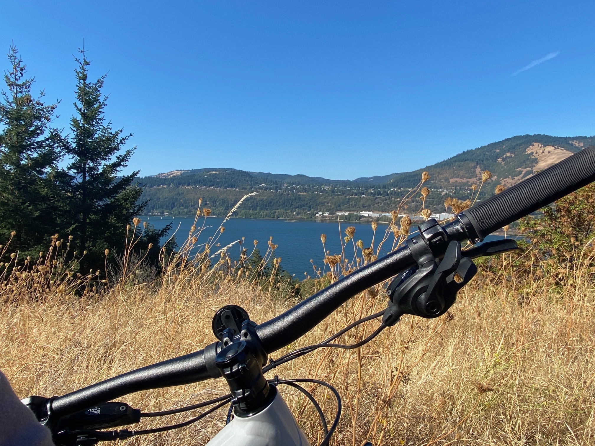 view over bicycle handlebars of mountain range